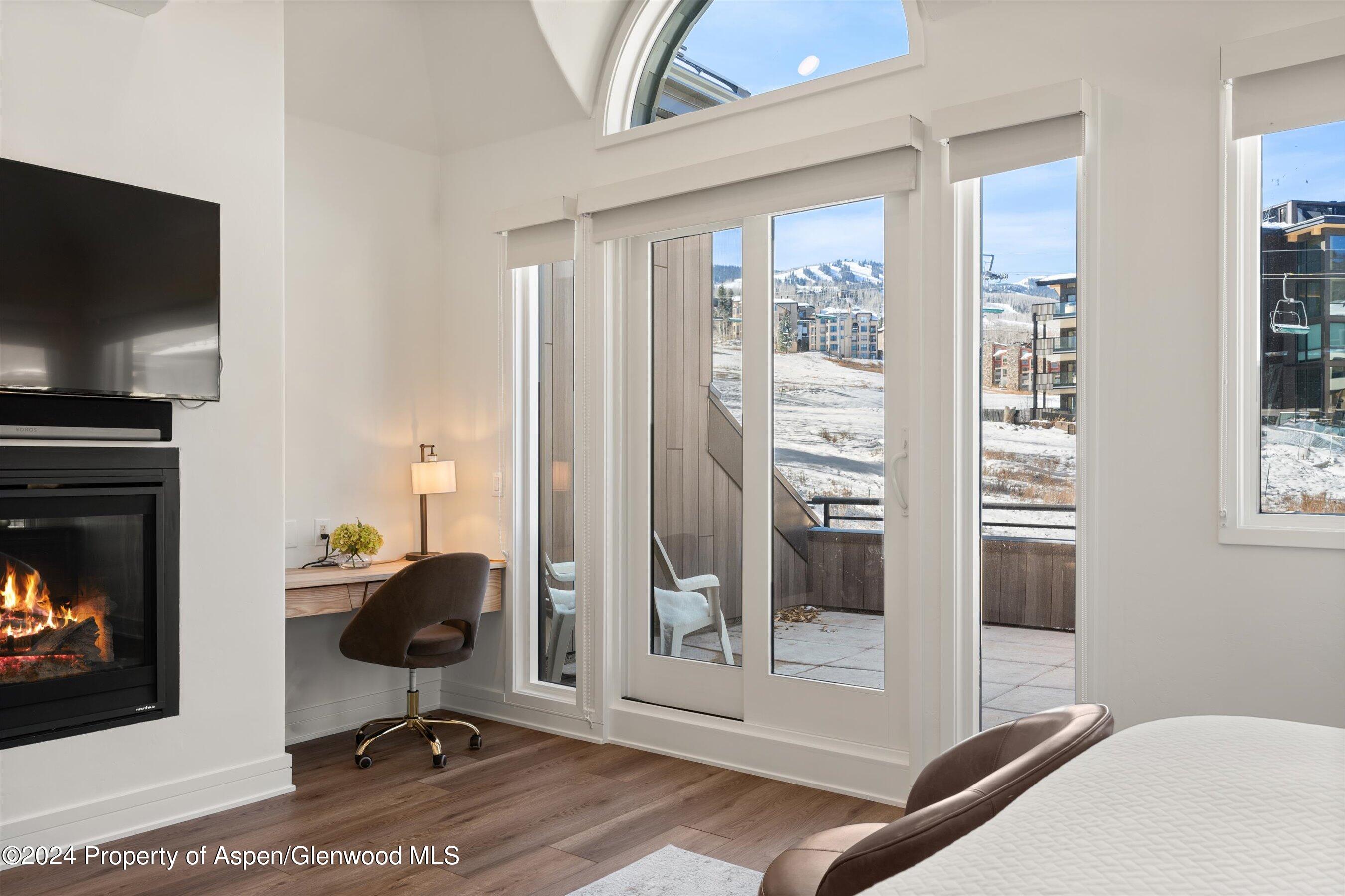 381 Ridge Road, Unit A5 Snowmass Village, CO 81615 - Photo 32 of 43 a workspace with wooden floor and a fireplace