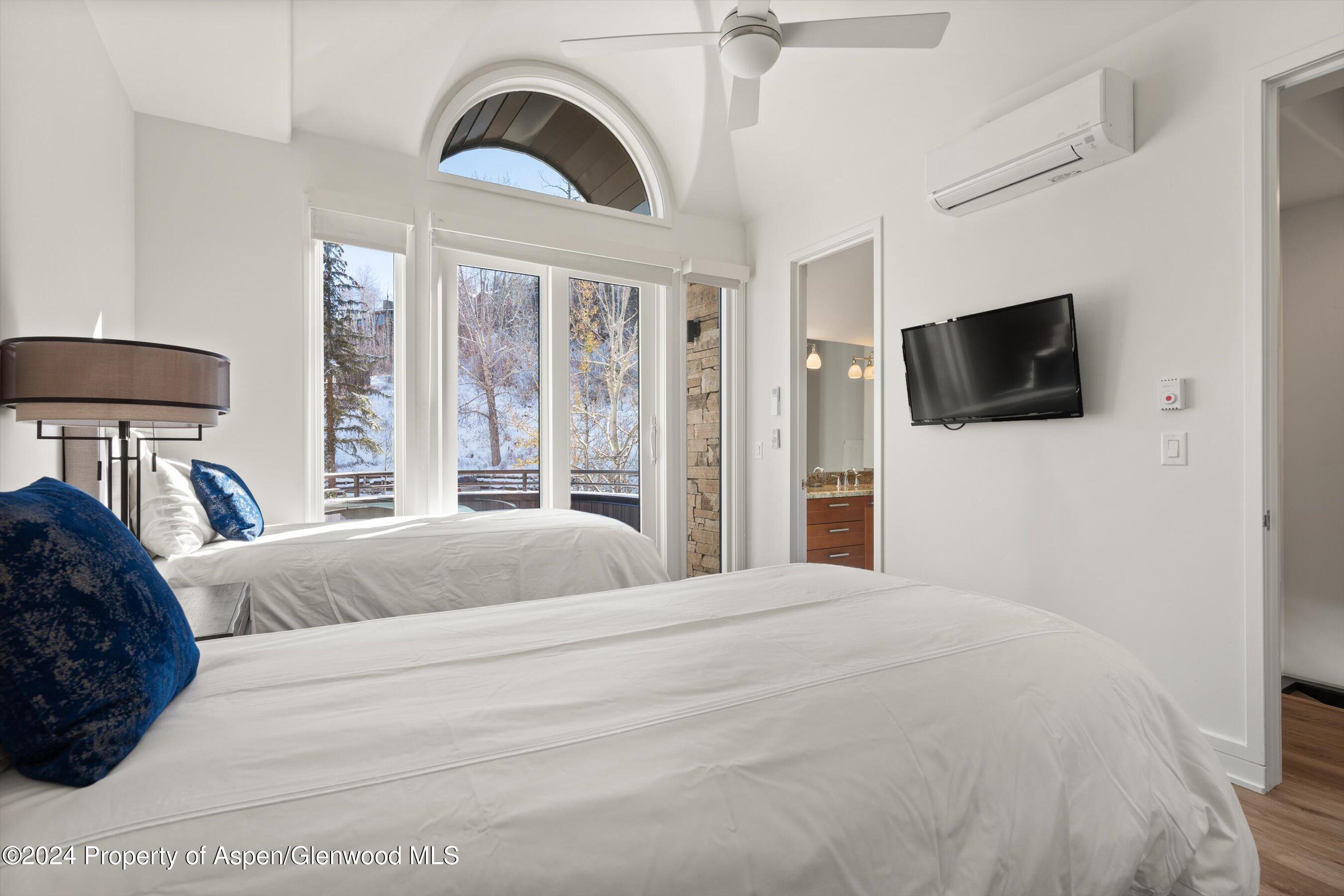 381 Ridge Road, Unit A5 Snowmass Village, CO 81615 - Photo 38 of 43 a bedroom with a bed and a flat screen tv