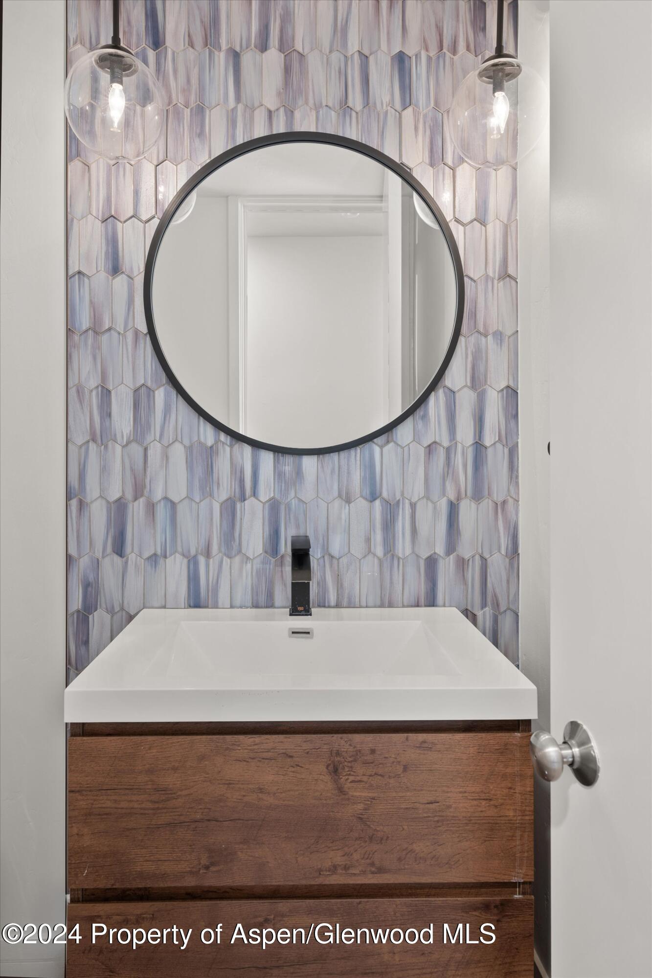381 Ridge Road, Unit A5 Snowmass Village, CO 81615 - Photo 42 of 43 a bathroom with a sink and a mirror