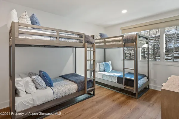 a bedroom with furniture and wooden floor