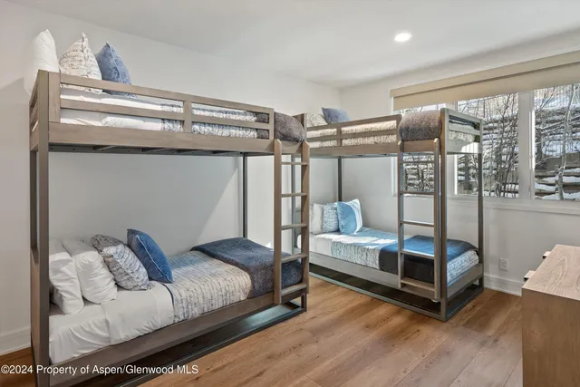 a bedroom with furniture and wooden floor