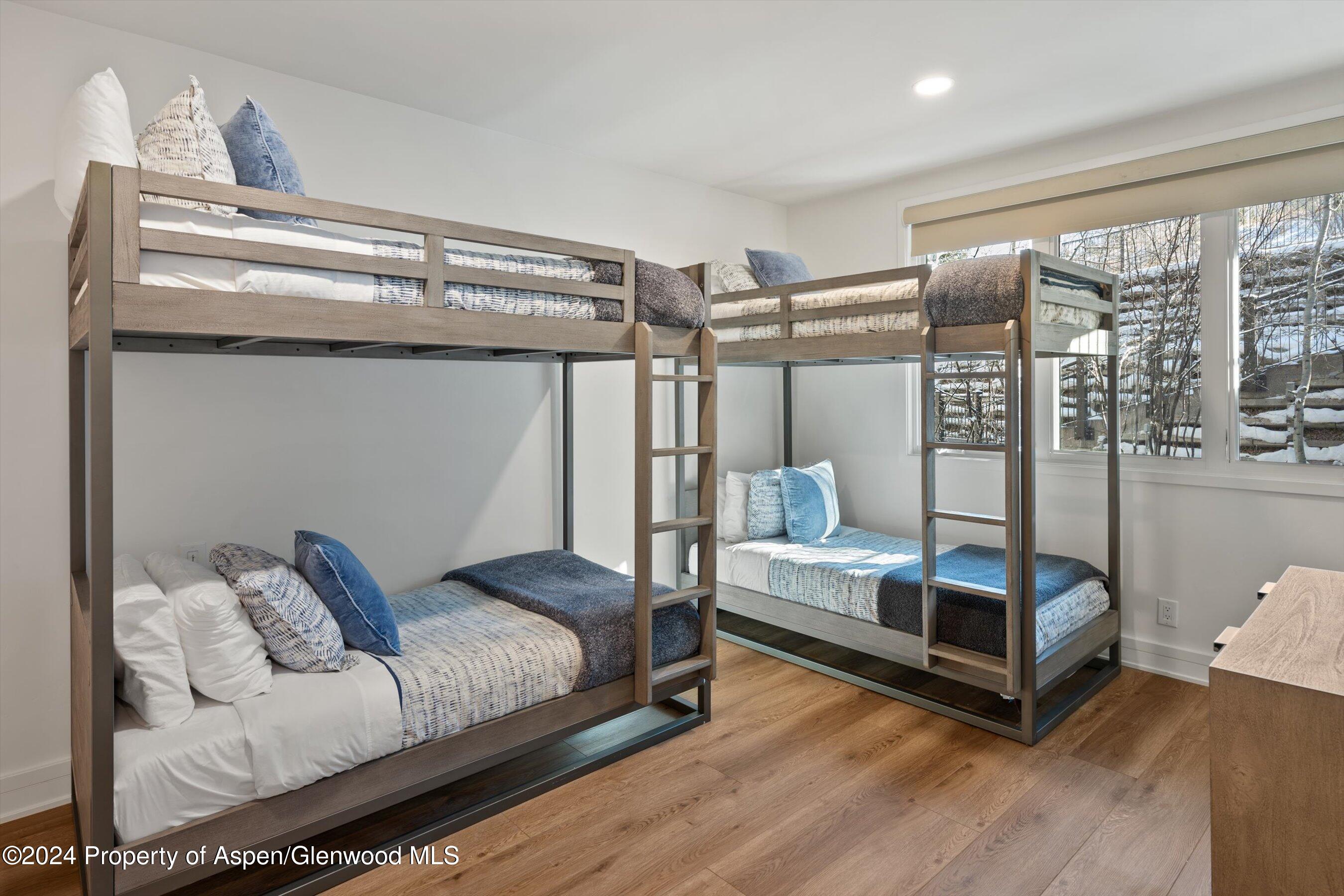 381 Ridge Road, Unit A5 Snowmass Village, CO 81615 - Photo 9 of 43 a bedroom with furniture and wooden floor
