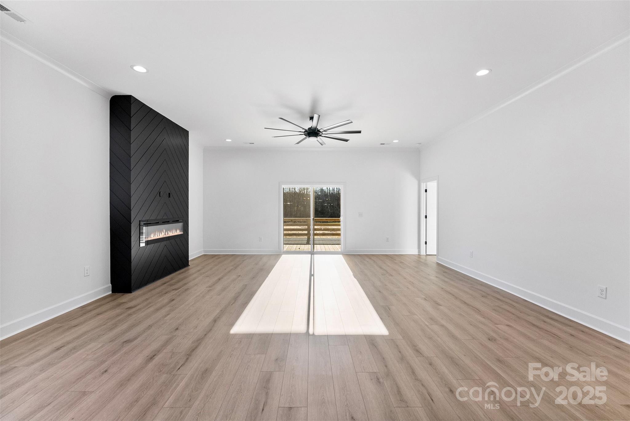 4005 Miller Road Salisbury, NC 28147 - Photo 12 of 46 a view of an empty room with wooden floor and a window