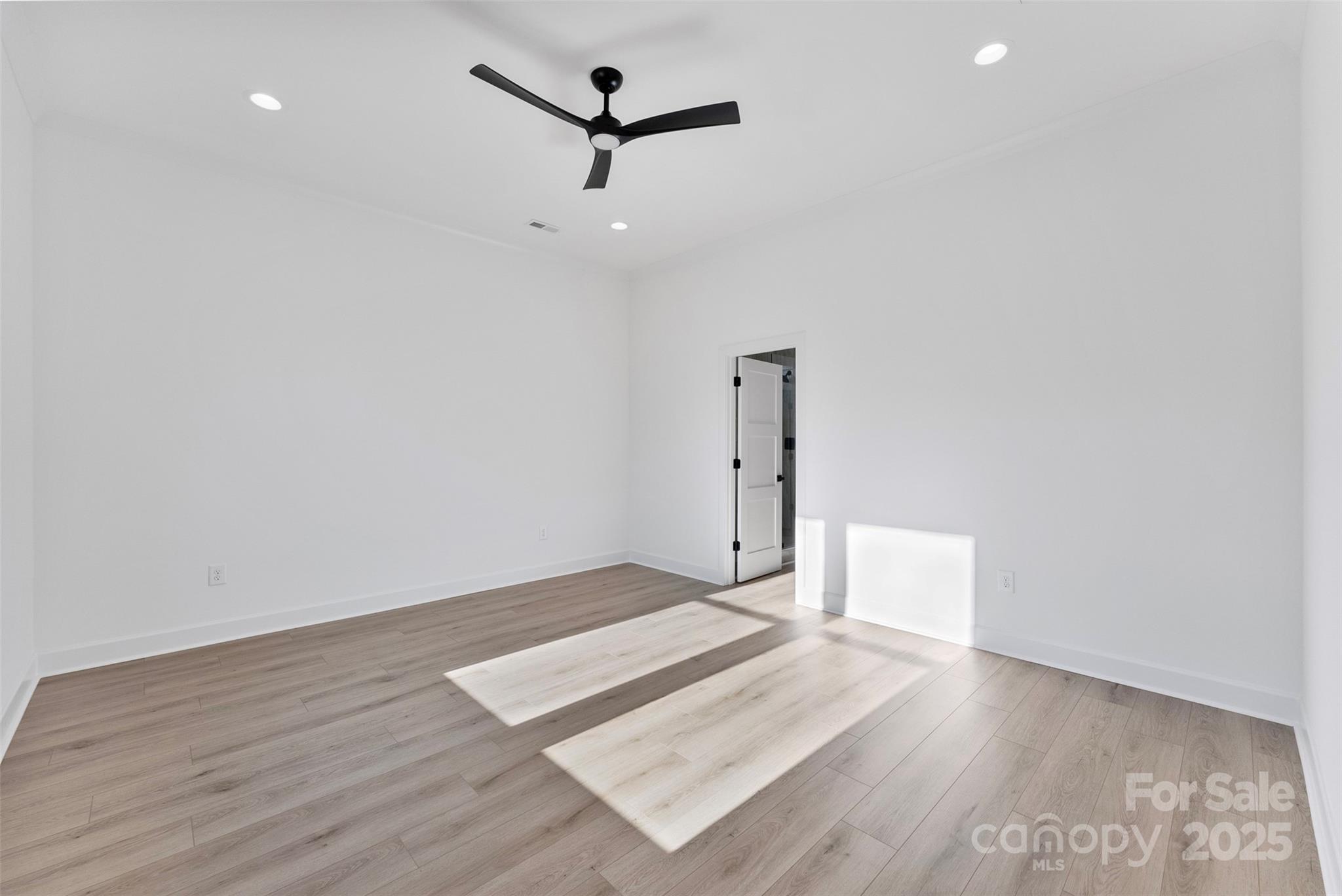 4005 Miller Road Salisbury, NC 28147 - Photo 18 of 46 a view of an empty room with wooden floor and a ceiling fan