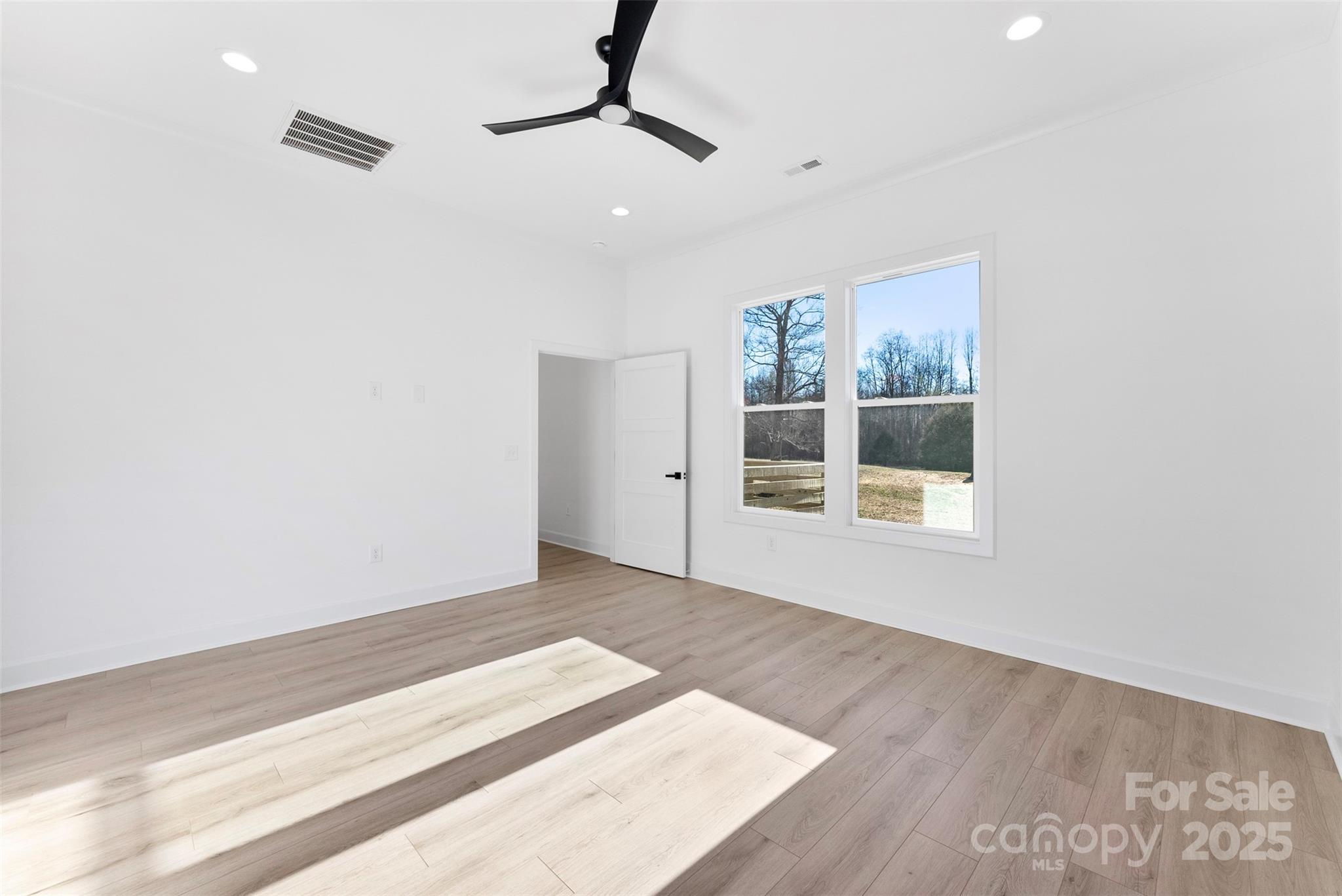 4005 Miller Road Salisbury, NC 28147 - Photo 20 of 46 a view of an empty room with a window and wooden floor