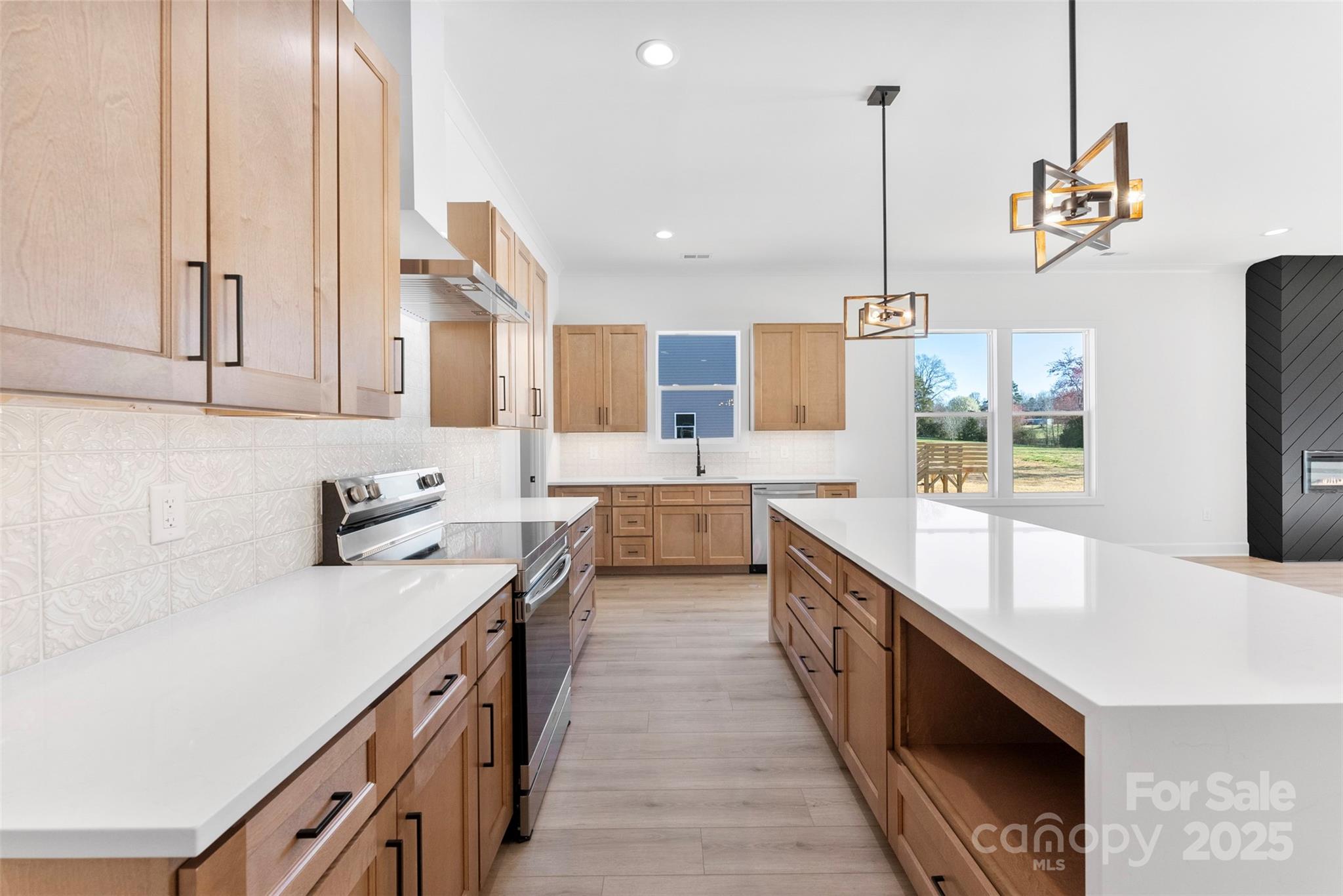 4005 Miller Road Salisbury, NC 28147 - Photo 5 of 46 a kitchen with stainless steel appliances granite countertop a sink a stove and a wooden floors