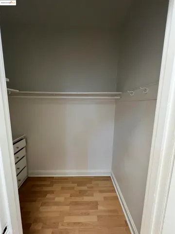 a view of a room with an empty space and wooden floor