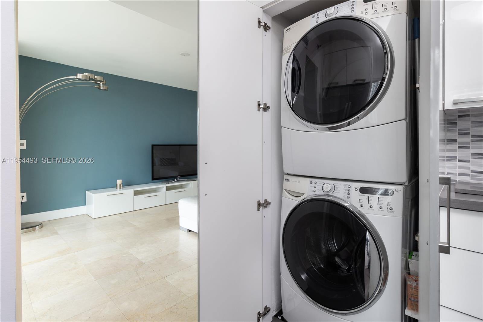 5900 Collins Avenue, Unit 1207 Miami Beach, FL 33140 - Photo 13 of 25 a living room with dryer and washer