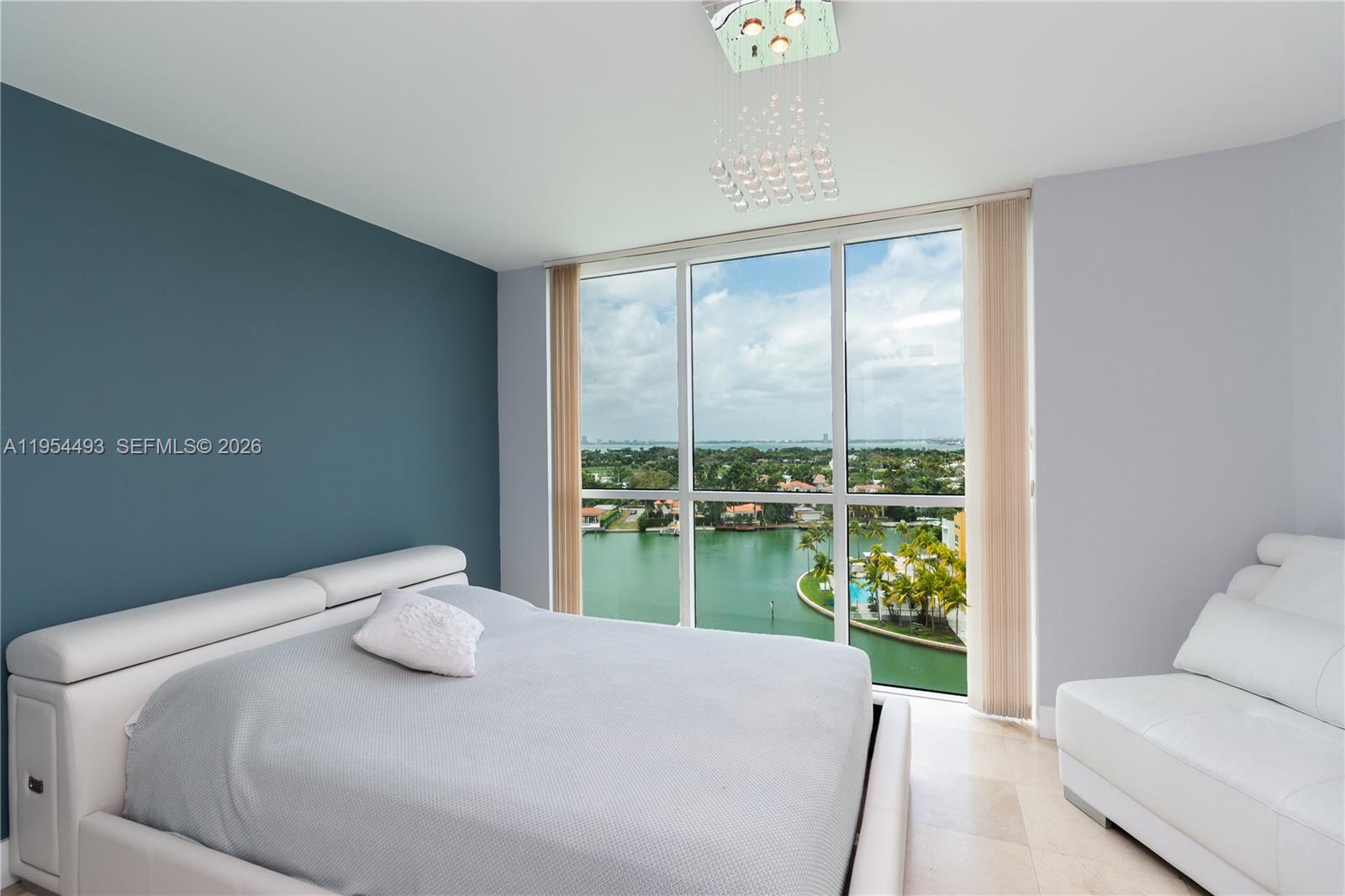 5900 Collins Avenue, Unit 1207 Miami Beach, FL 33140 - Photo 14 of 25 a bedroom with a bed and a large window