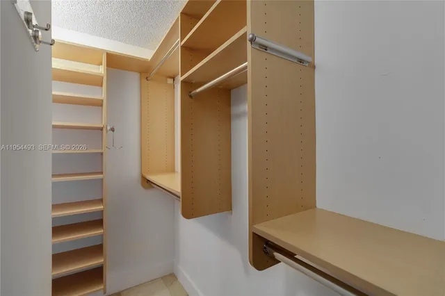 a bathroom with a bathtub shower sink and mirror