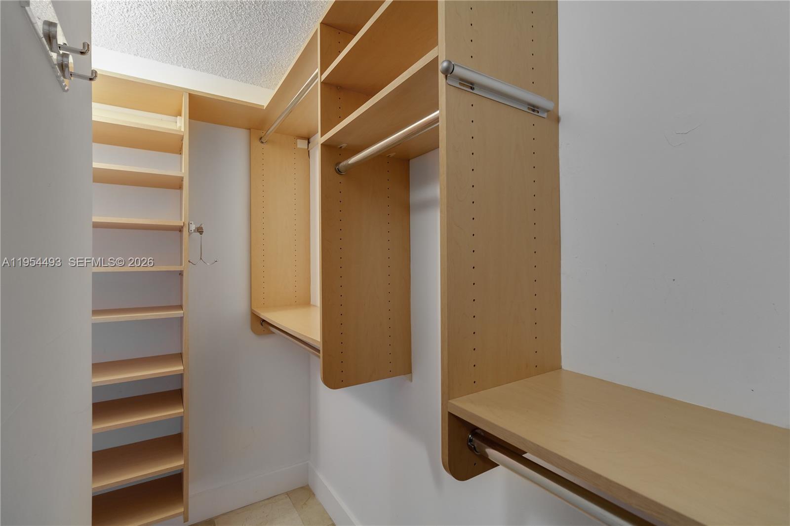 5900 Collins Avenue, Unit 1207 Miami Beach, FL 33140 - Photo 15 of 25 a view of walk in closet with empty racks