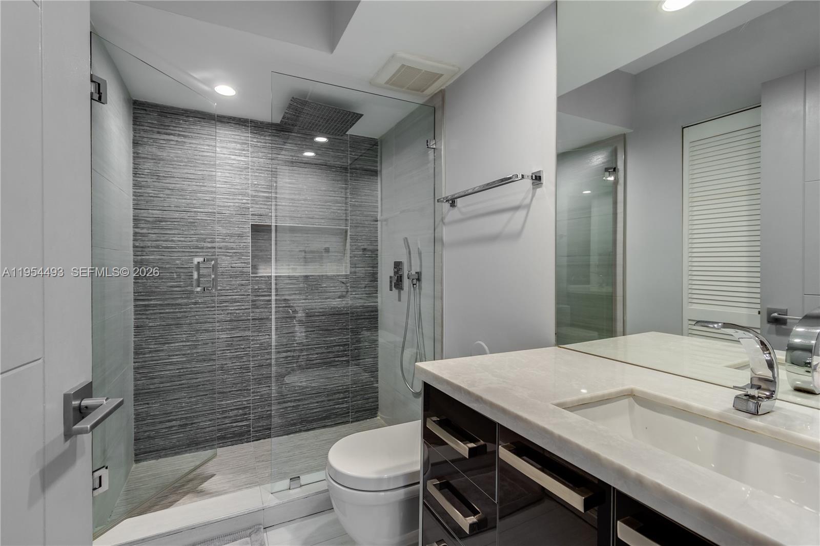 5900 Collins Avenue, Unit 1207 Miami Beach, FL 33140 - Photo 20 of 25 a bathroom with a sink a toilet and shower