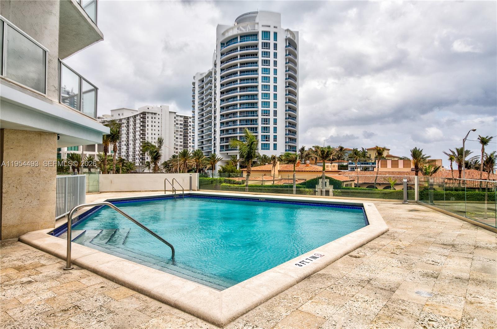 5900 Collins Avenue, Unit 1207 Miami Beach, FL 33140 - Photo 22 of 25 a view of swimming pool from a terrace