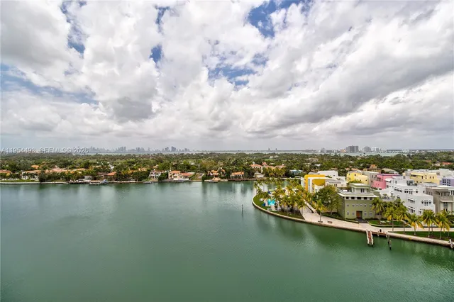 a dining room with furniture and a large window