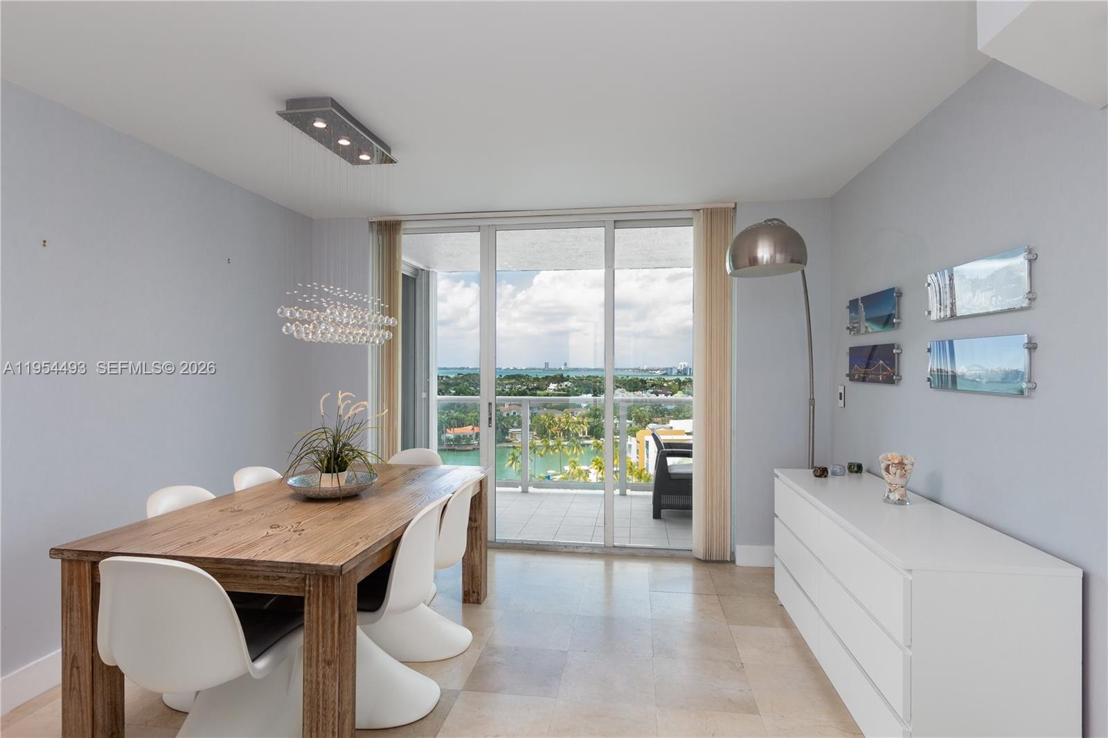 5900 Collins Avenue, Unit 1207 Miami Beach, FL 33140 - Photo 4 of 25 a dining room with furniture and a large window
