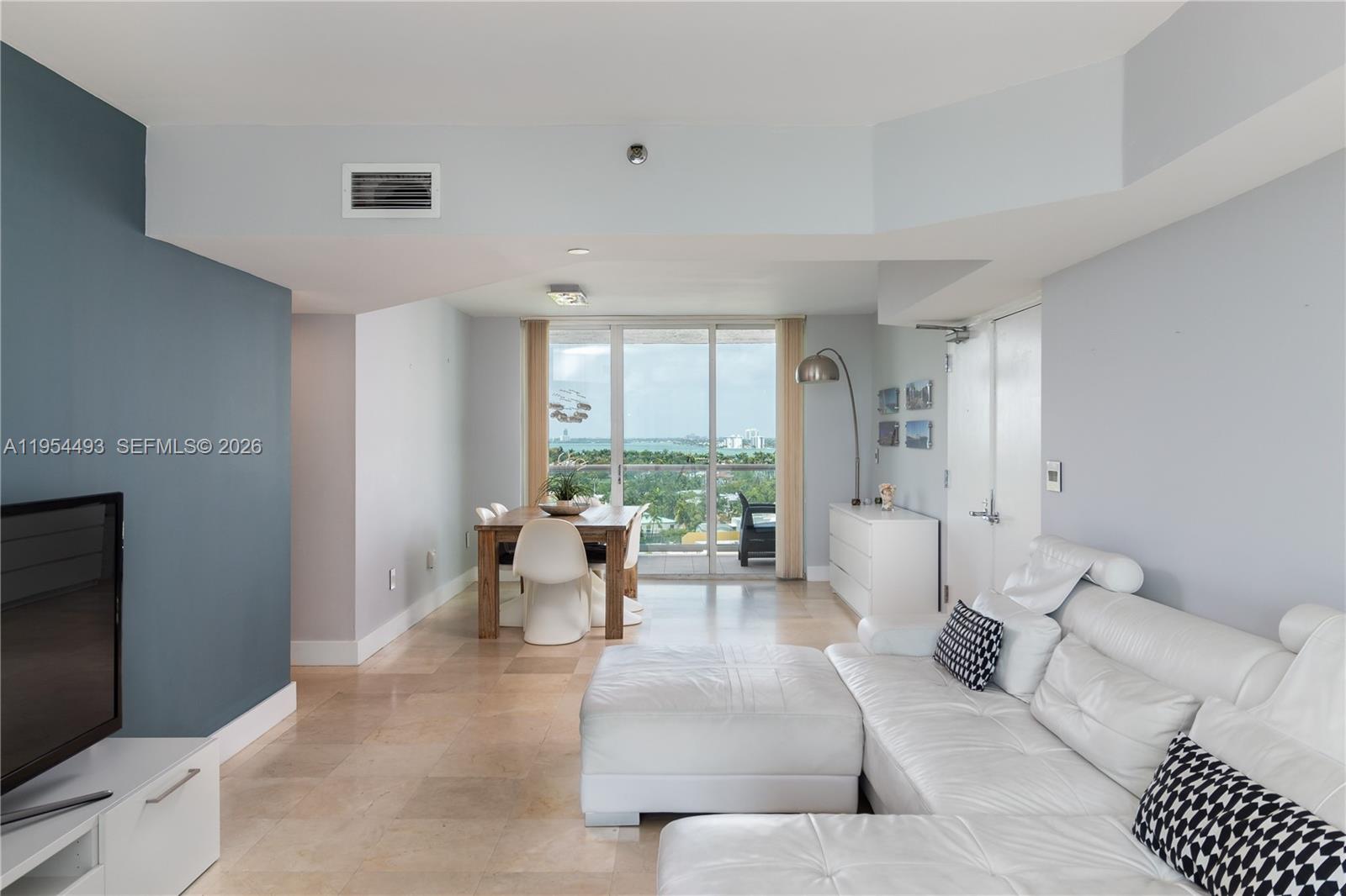 5900 Collins Avenue, Unit 1207 Miami Beach, FL 33140 - Photo 5 of 25 a living room with furniture and a large window