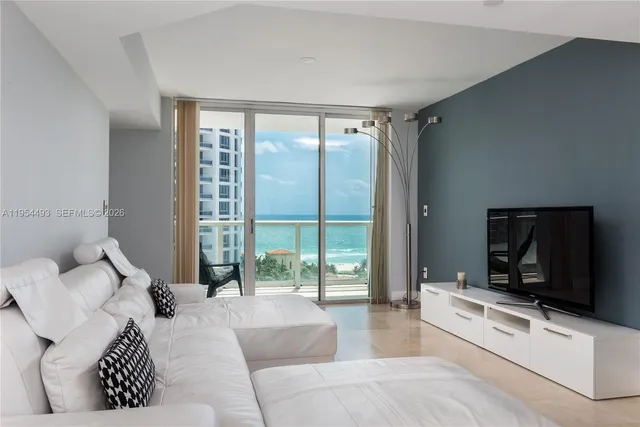 a bathroom with a glass shower door and a window