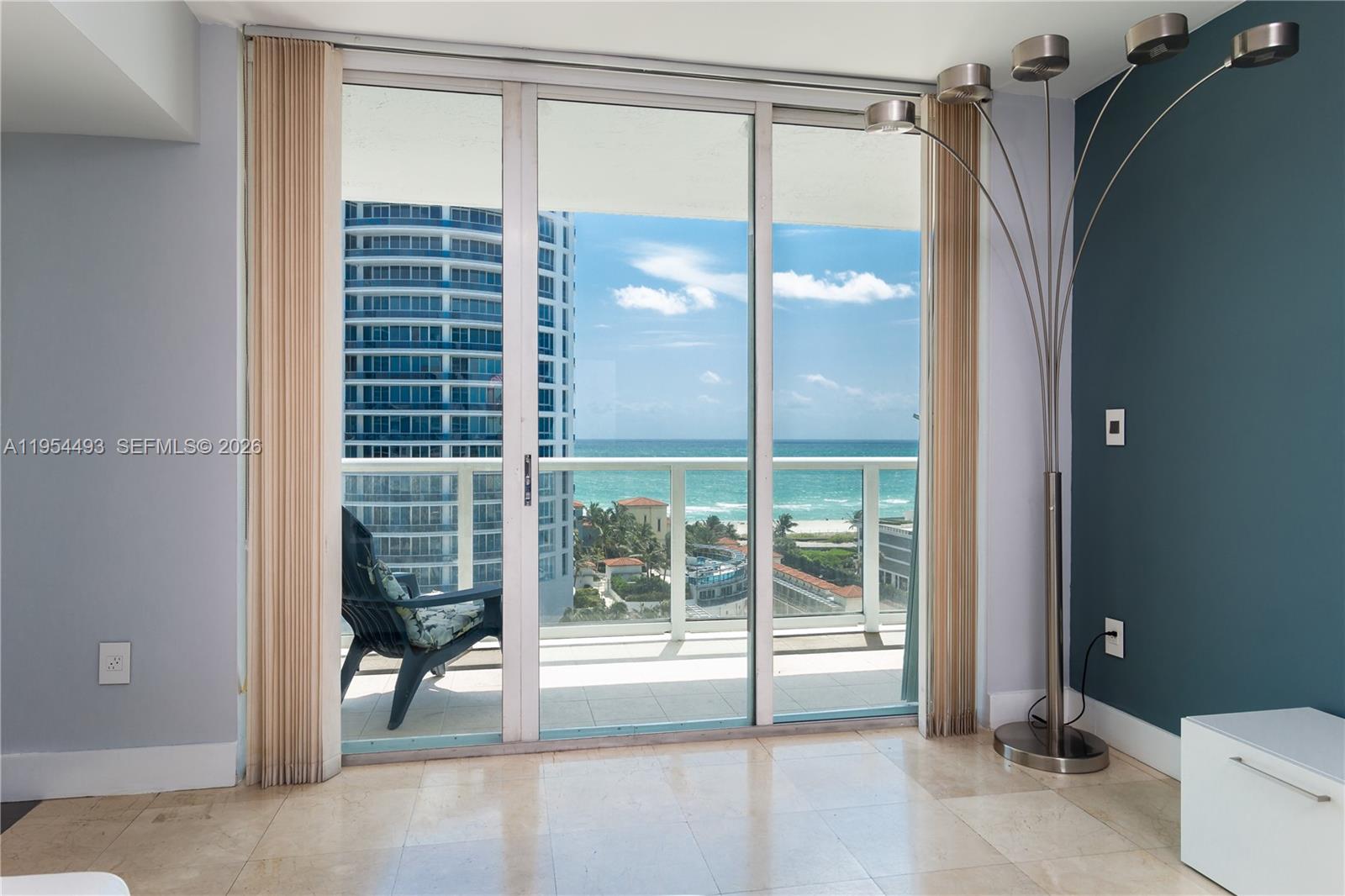 5900 Collins Avenue, Unit 1207 Miami Beach, FL 33140 - Photo 7 of 25 a bathroom with a glass shower door and a window