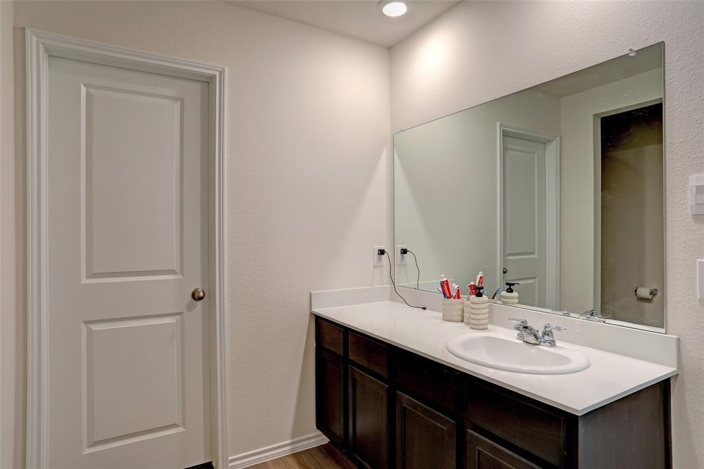 6517 Waterfall Lane Princeton, TX 75407 - Photo 15 of 19 a bathroom with a sink and a mirror
