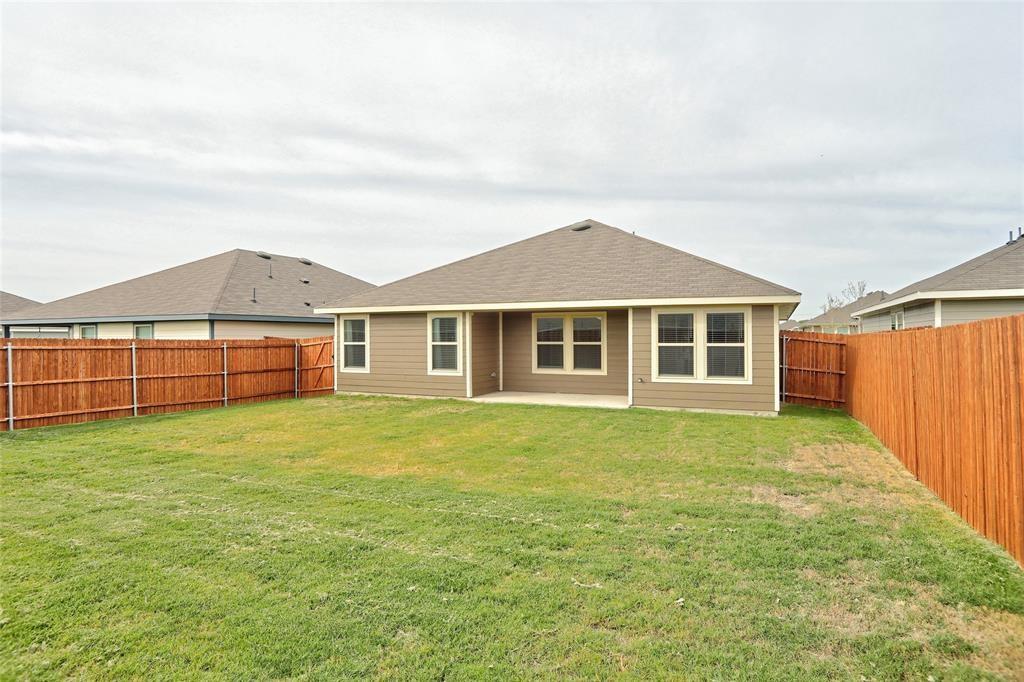 6517 Waterfall Lane Princeton, TX 75407 - Photo 16 of 19 a view of a yard in front of a house with wooden fence