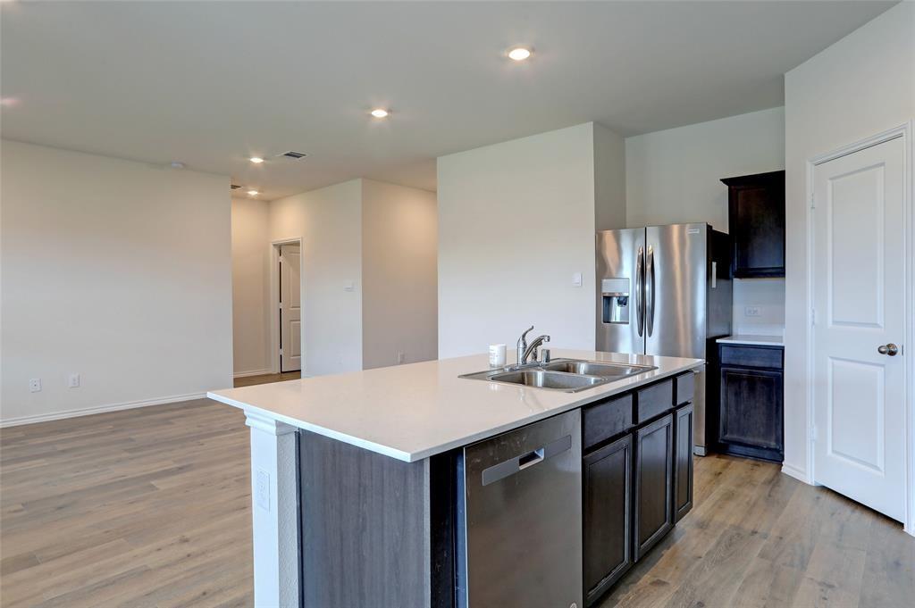 6517 Waterfall Lane Princeton, TX 75407 - Photo 3 of 19 a kitchen with stainless steel appliances a sink and a refrigerator