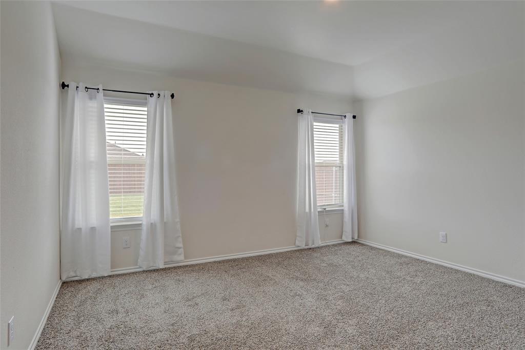 6517 Waterfall Lane Princeton, TX 75407 - Photo 8 of 19 an empty room with windows and closet