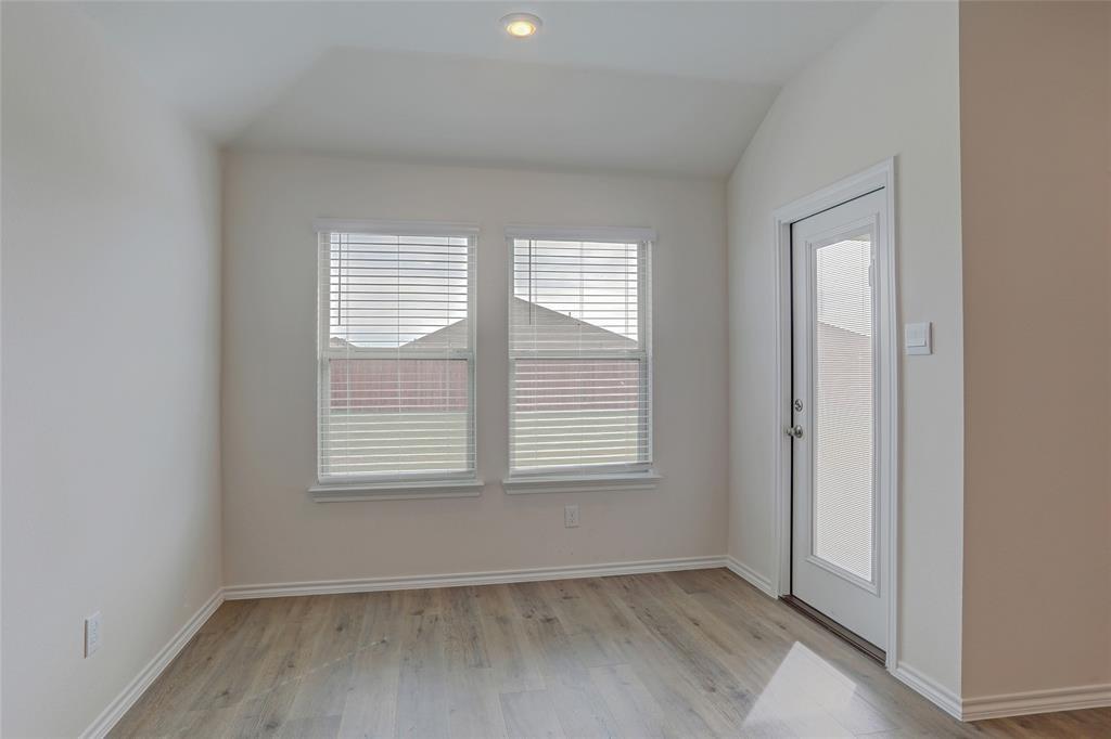 6517 Waterfall Lane Princeton, TX 75407 - Photo 9 of 19 an empty room with wooden floor and windows
