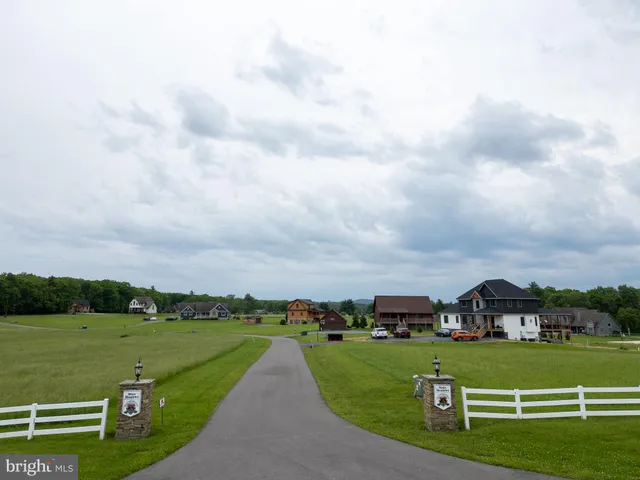 a view of a grassy field with clear sky