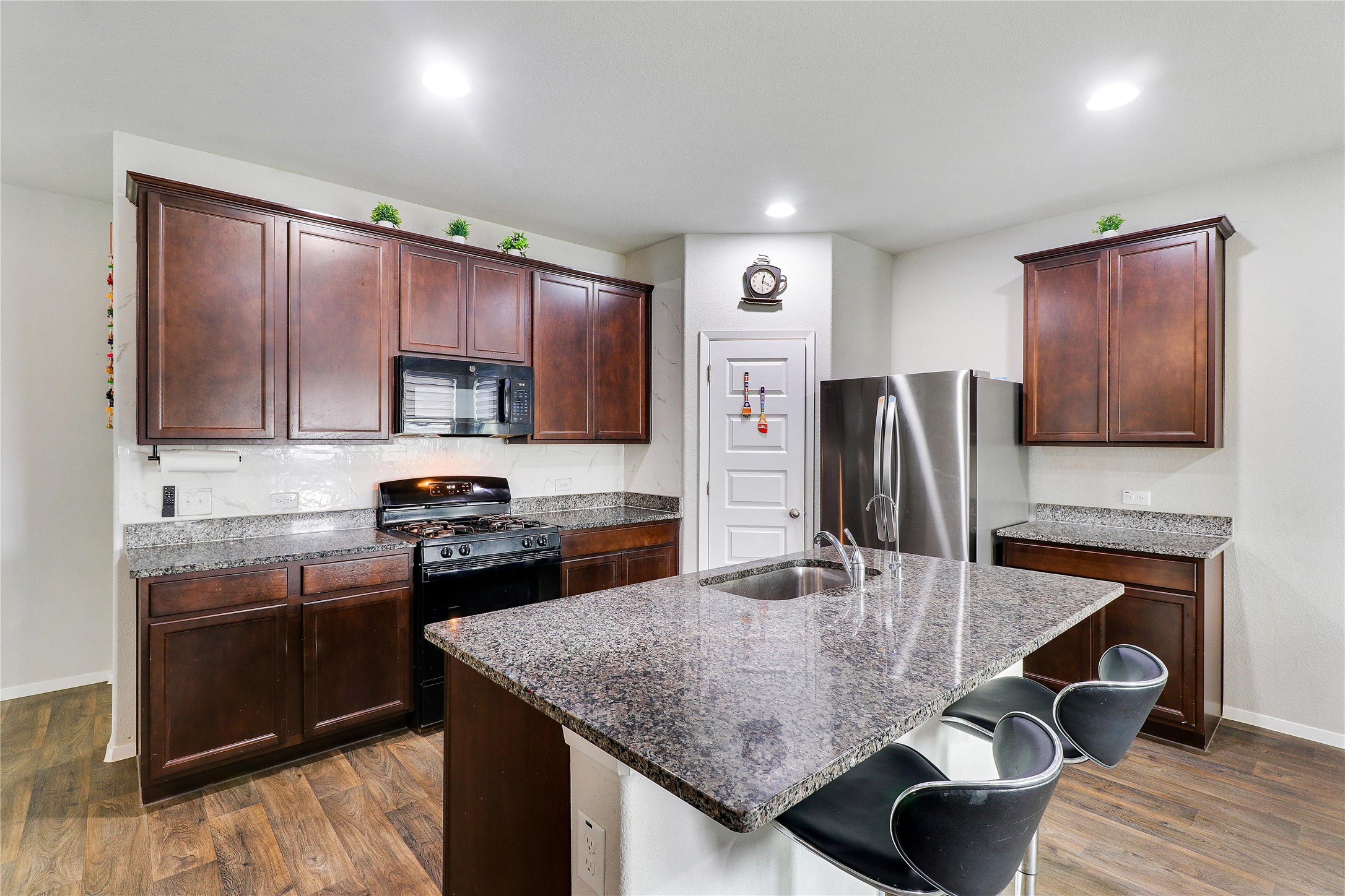33 Bent Trl Lane Georgetown, TX 78628 - Photo 8 of 40 a kitchen with kitchen island granite countertop a sink cabinets and stainless steel appliances