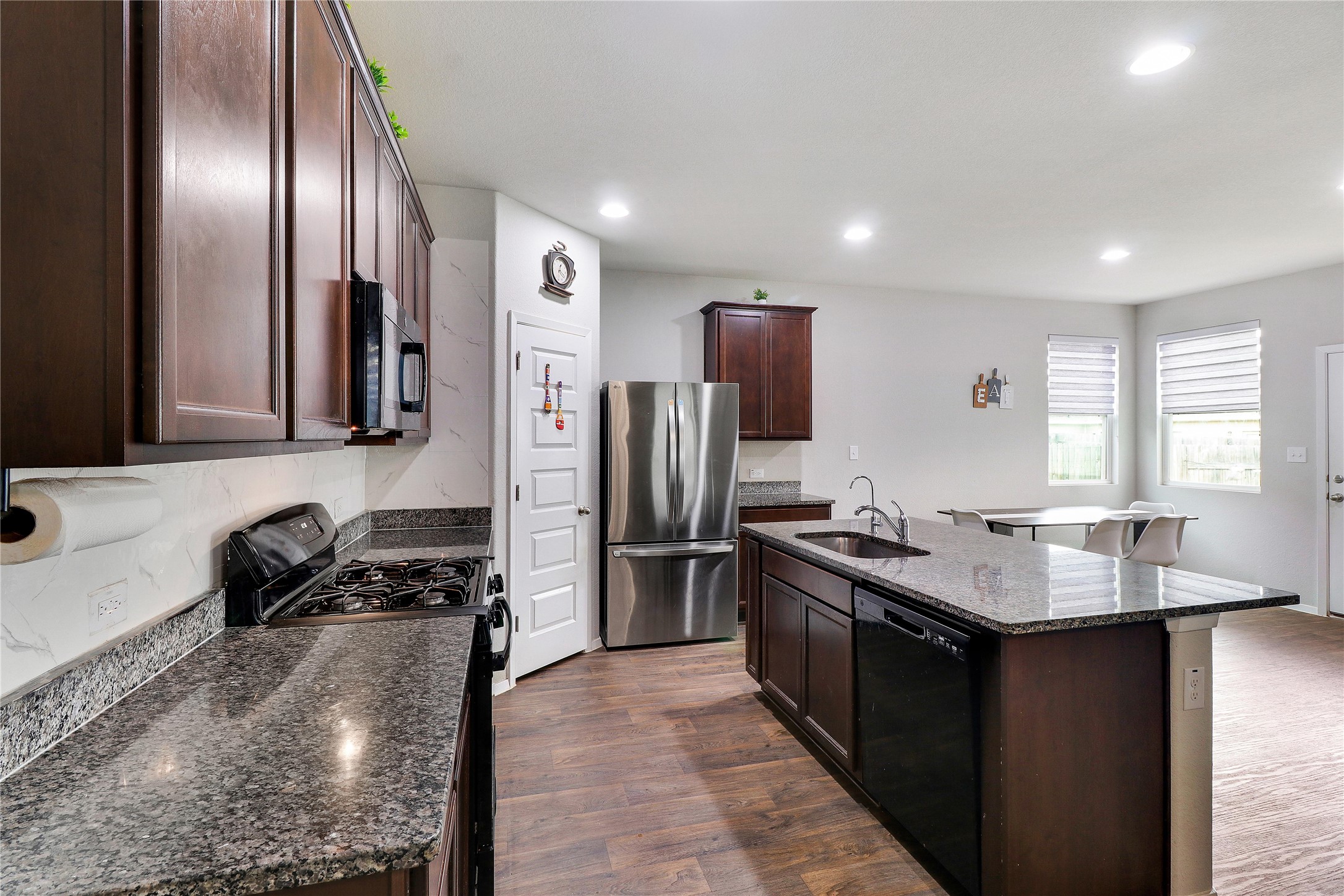 33 Bent Trl Lane Georgetown, TX 78628 - Photo 9 of 40 a kitchen with kitchen island granite countertop stainless steel appliances a sink stove and refrigerator