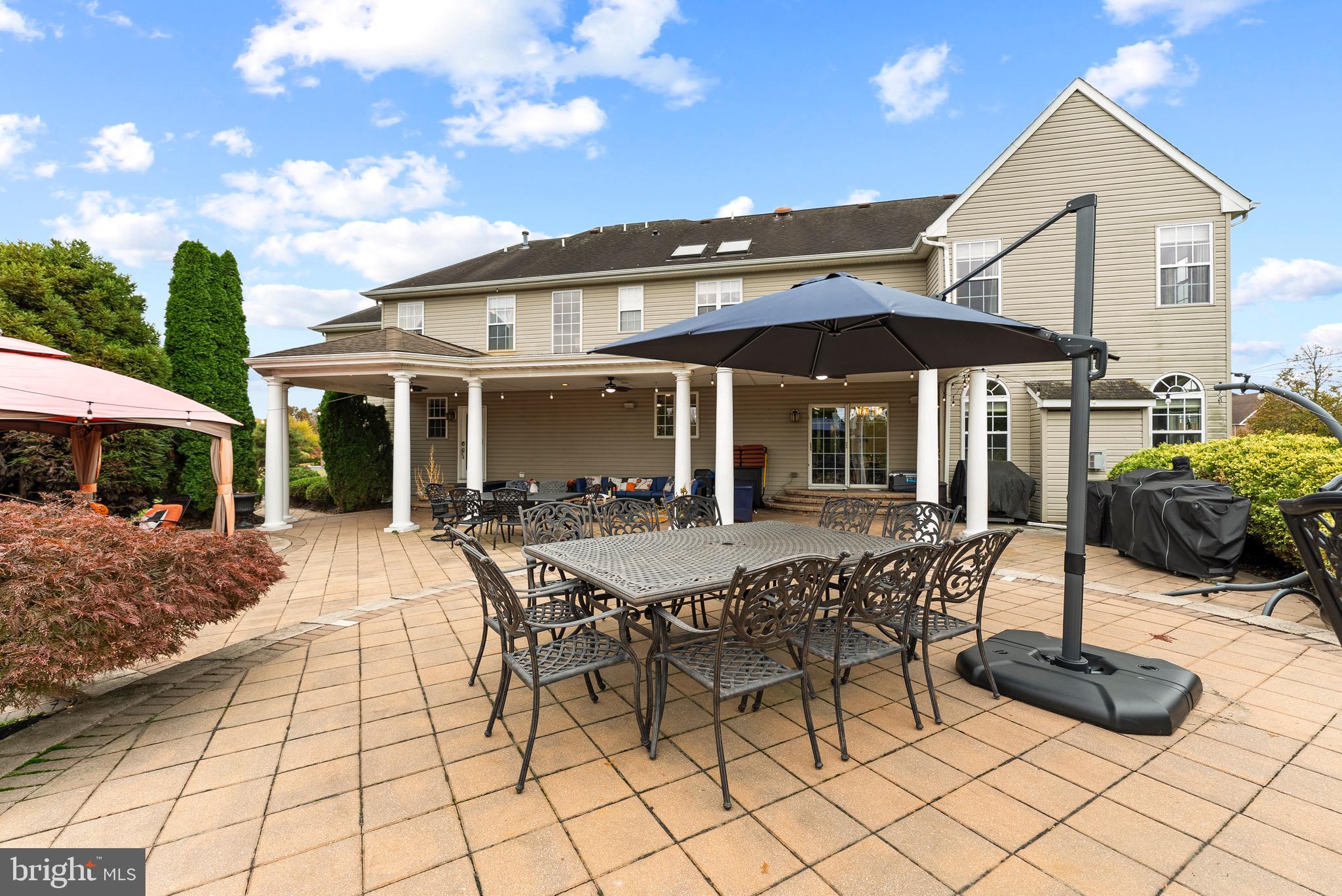 8 Sherwood Lane Columbus, NJ 08022 - Photo 82 of 85 a patio with a table and chairs under an umbrella