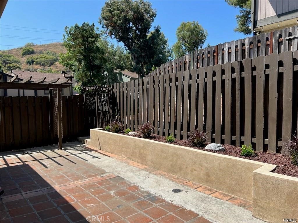 10831 Roycroft Street, Unit 72 Sun Valley, CA 91352 - Photo 14 of 30 a view of a wooden fence with a pathway