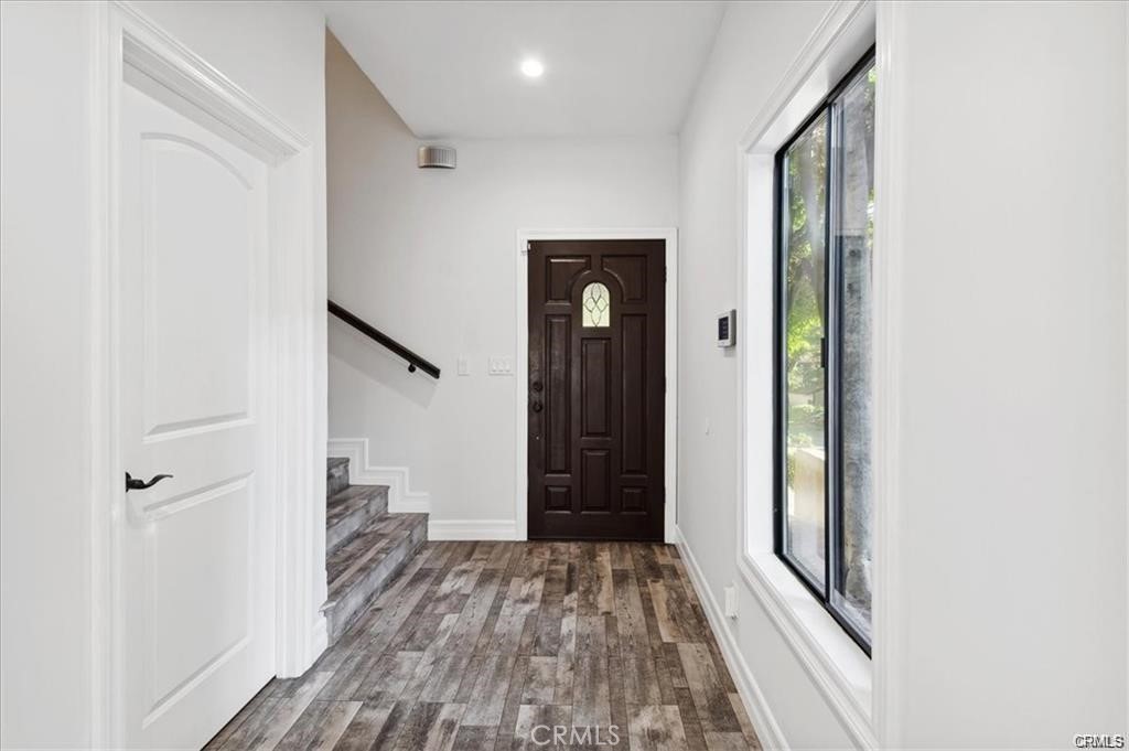 10831 Roycroft Street, Unit 72 Sun Valley, CA 91352 - Photo 5 of 30 a view of a hallway with wooden floor and staircase