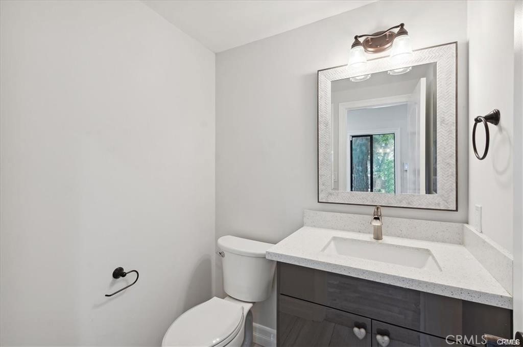 10831 Roycroft Street, Unit 72 Sun Valley, CA 91352 - Photo 7 of 30 a bathroom with a sink vanity mirror and toilet