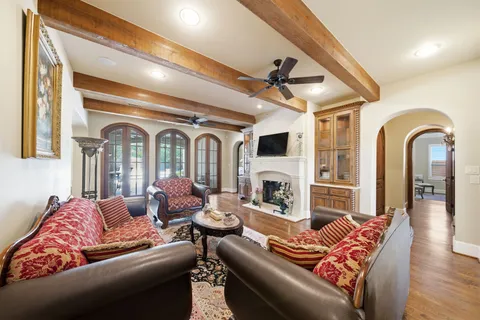 a living room with furniture fireplace and wooden floor
