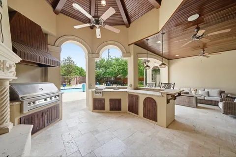 a open kitchen with stainless steel appliances granite countertop a stove a sink dishwasher and white cabinets with wooden floor