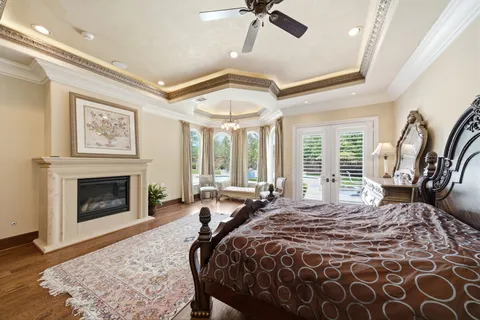 a spacious bedroom with a large bed and a fireplace