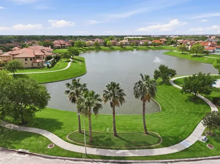 an aerial view of residential houses with outdoor space and river