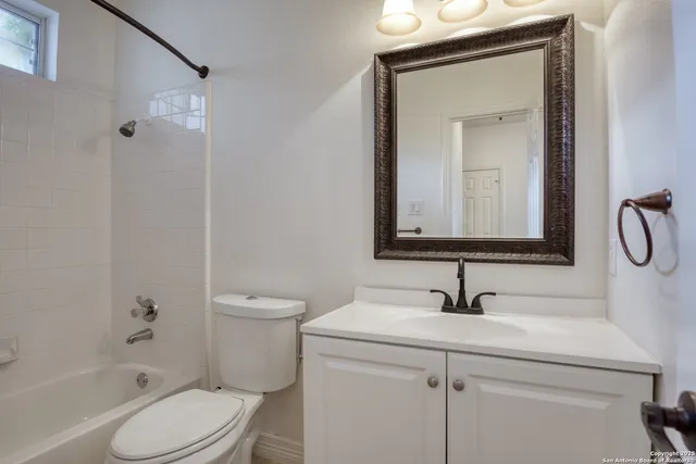 a bathroom with a toilet sink shower and mirror