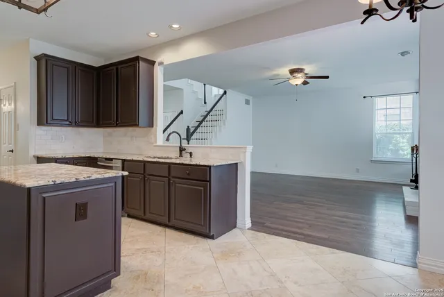 a kitchen with a sink a stove and cabinets