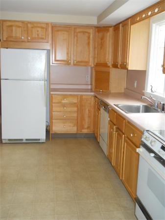 41 Gregory Road Wakefield, MA 01880 - Photo 14 of 24 a kitchen with stainless steel appliances granite countertop a refrigerator a sink and white cabinets