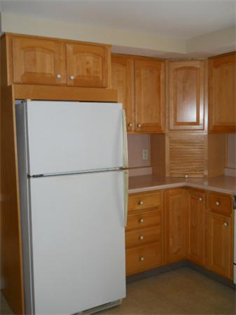 41 Gregory Road Wakefield, MA 01880 - Photo 15 of 24 a white refrigerator freezer sitting in a kitchen
