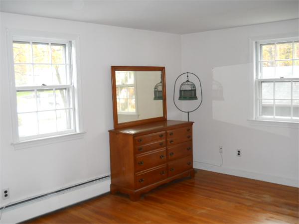 41 Gregory Road Wakefield, MA 01880 - Photo 18 of 24 a view of a dresser with wooden floor and windows