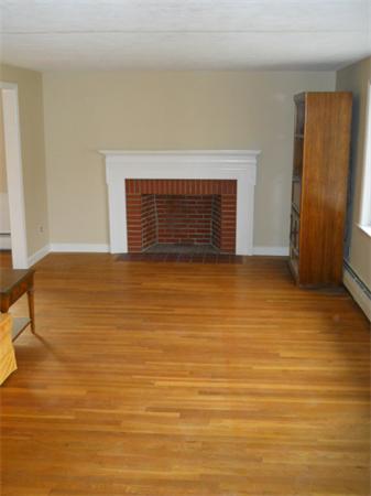 41 Gregory Road Wakefield, MA 01880 - Photo 10 of 24 a view of empty room with wooden floor and fireplace