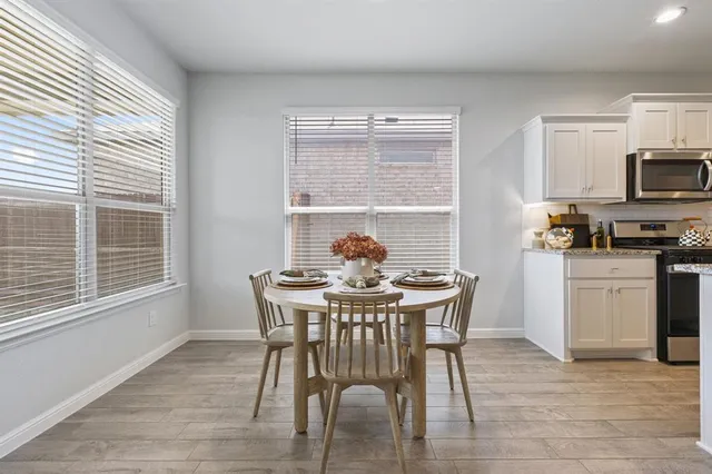 a view of a dining room with furniture and a window