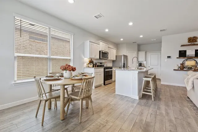 a view of a dining room with furniture and wooden floor