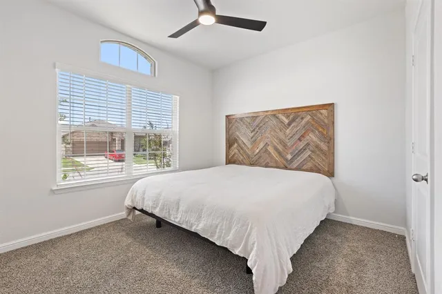 a bed sitting in a bedroom next to a window