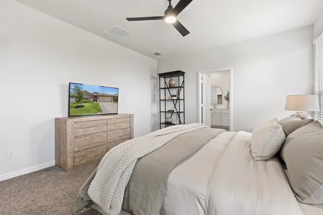 a bedroom with a bed and a dresser