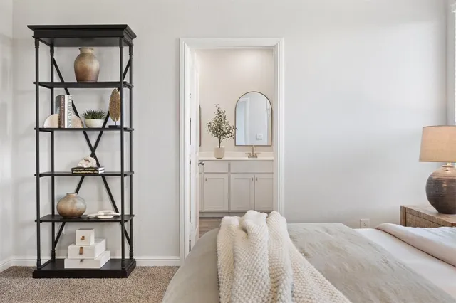 a bedroom with a bed and a mirror