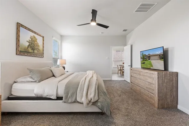 a bedroom with a bed and a flat screen tv